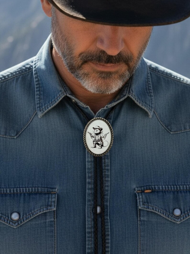 Cowboy wearing an opossum bolo tie for men wearing a denim shirt with a decorative bolo tie against a blurred natural background