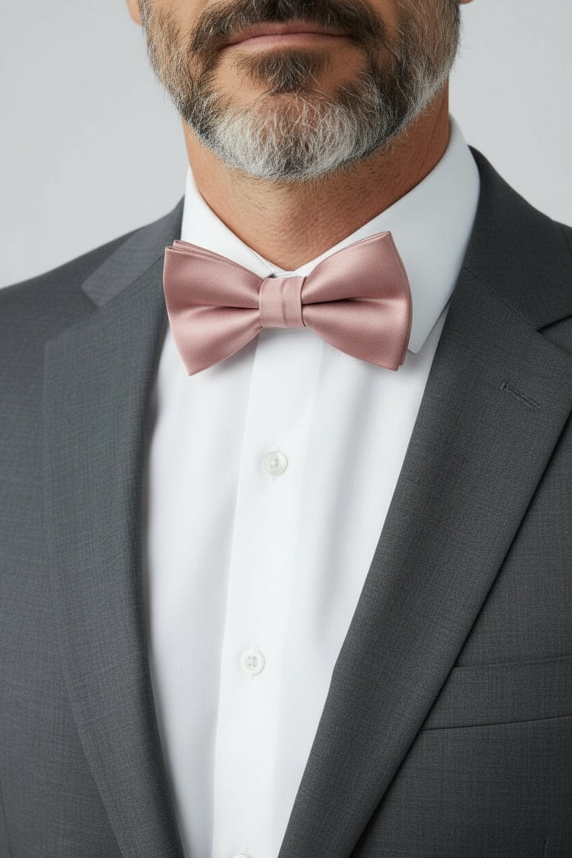 Groomsman in a rose gold bow tie for men in a wedding.