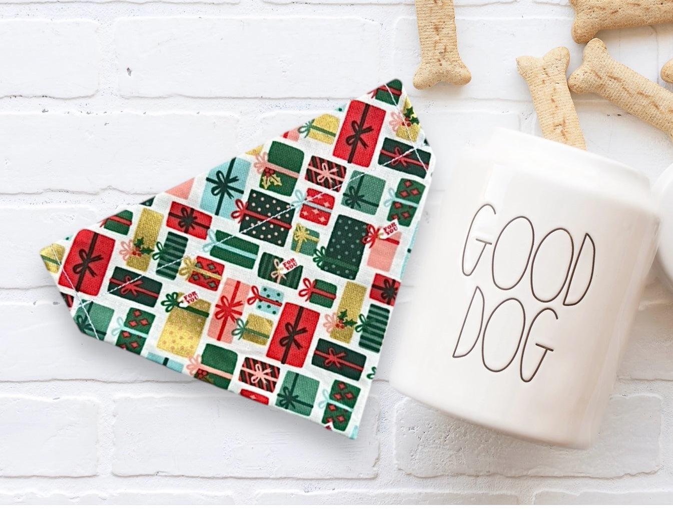 Gift patterned Christmas bandana beside a white mug that says GOOD DOG