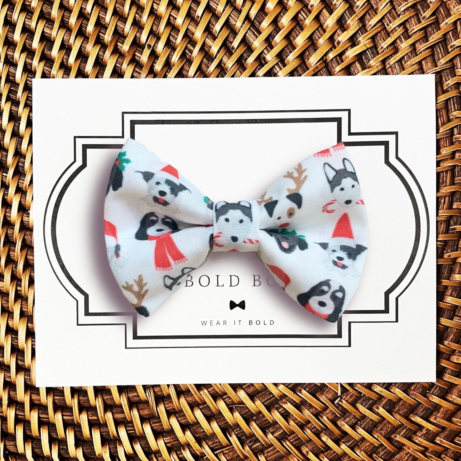 a white bow with black and red dogs on it