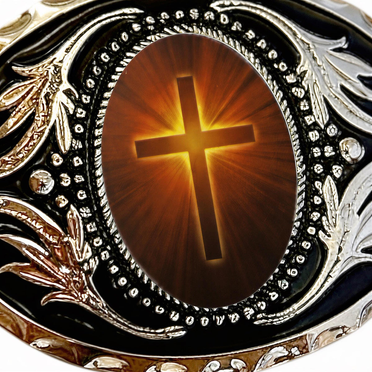 a large, ornate, and intricately designed cross on a piece of jewelry, surrounded by a decorative border.