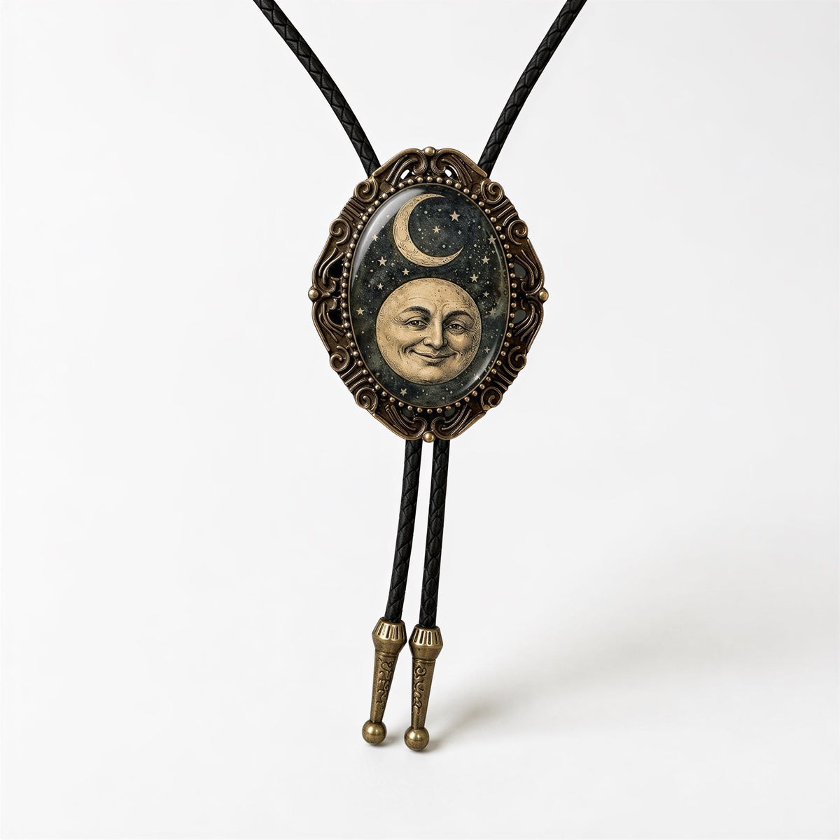 A decorative pendant featuring a moon and crescent symbol, with a smiling face, is displayed on a black cord.