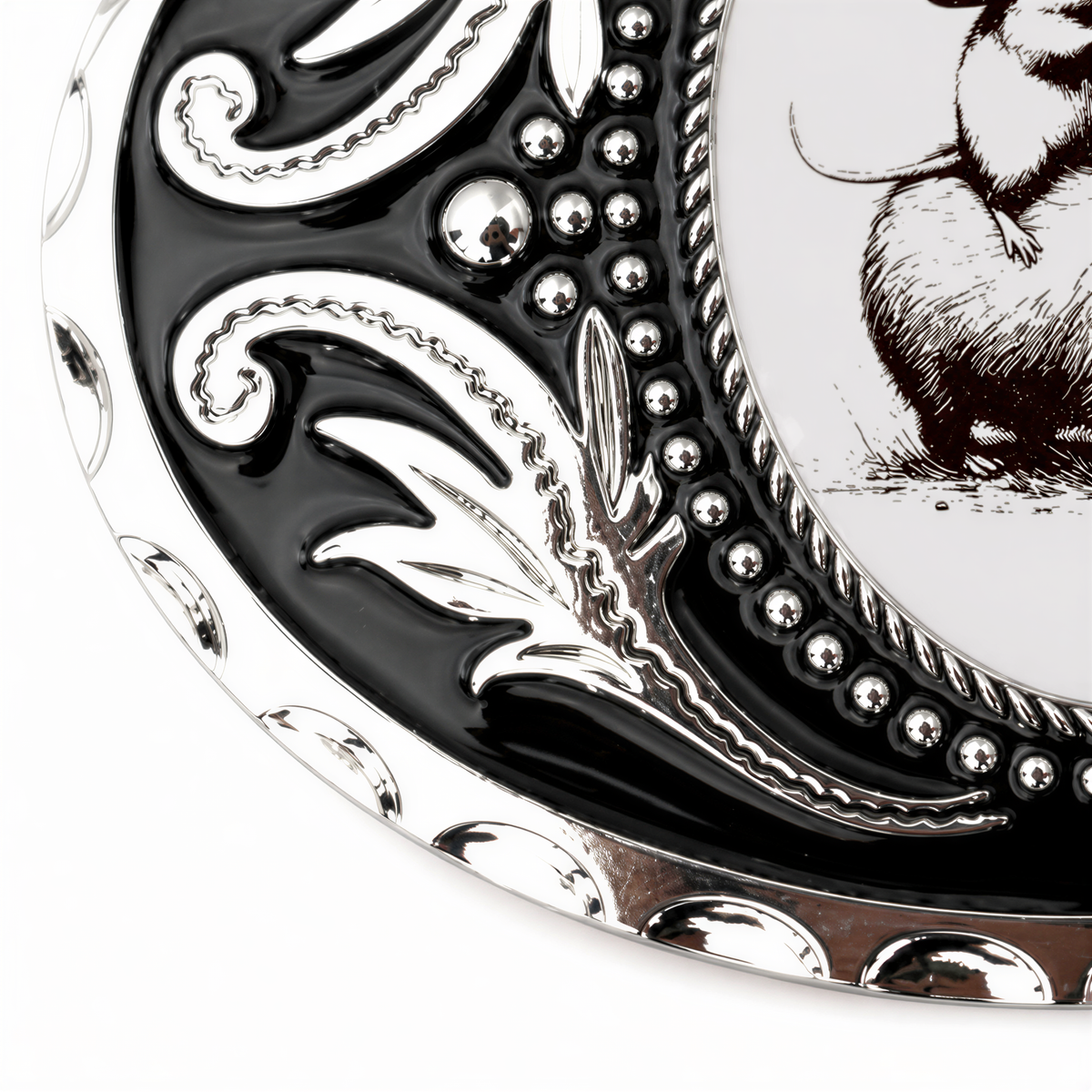 a close-up view of a decorative metal plate with a black and white design.
