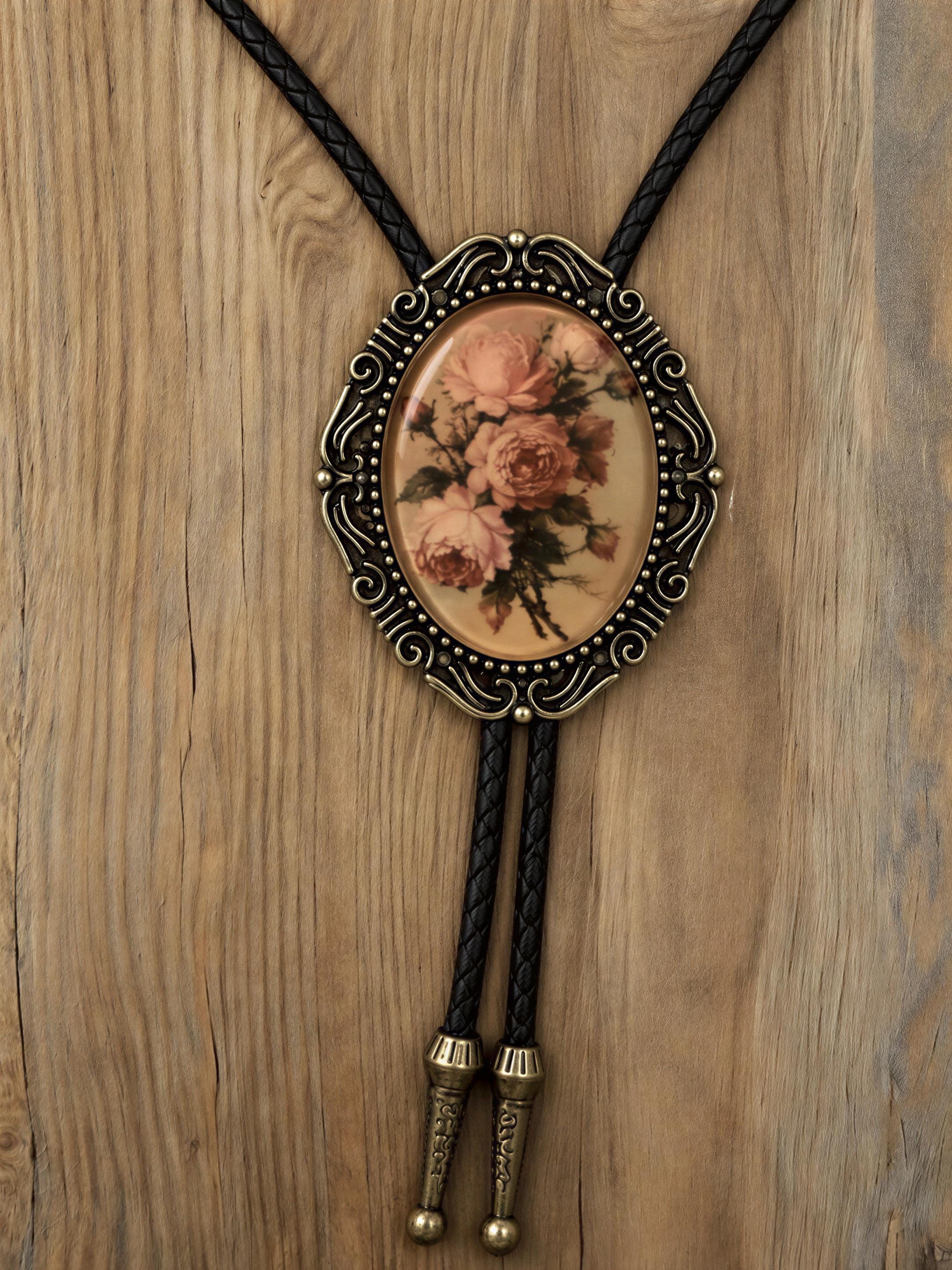 Vintage rose bolo tie mens floral neckwear rustic antique brass oval pendant black vegan leather cord.