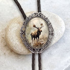 Bolo tie with moose in silver with leather cord.