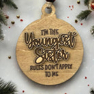 a wooden ornament that says, i'm the youngest son rules don