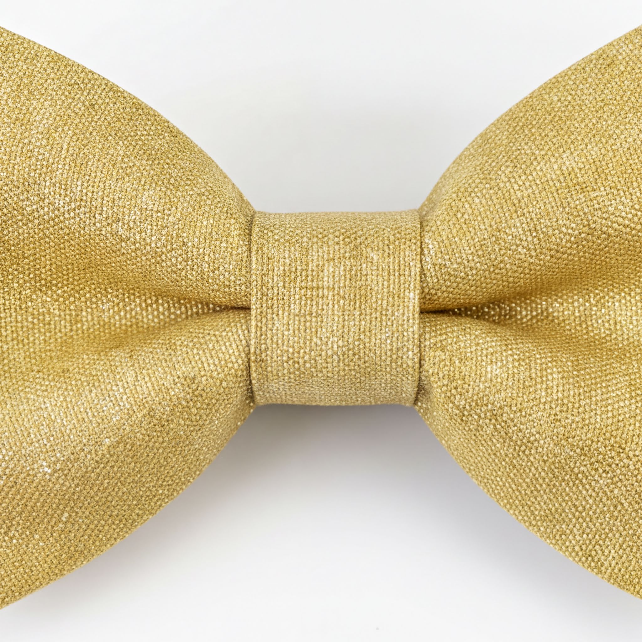 A gold-colored bow tie is shown against a white background.