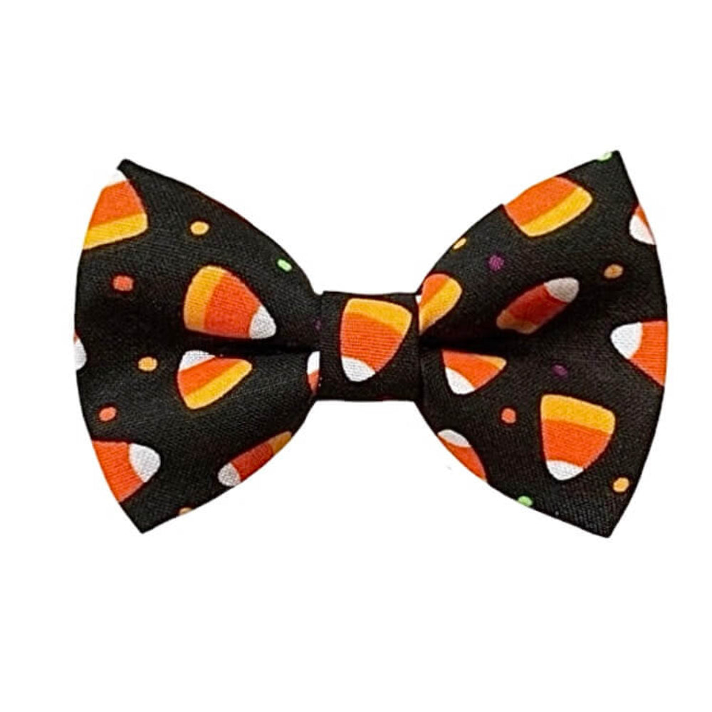 A candy corn Halloween dog bowtie in orange, white, and small multicolor accents, shown on a plain white background.