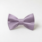 A purple satin bow tie is displayed against a white background.