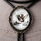 A decorative pendant featuring a detailed illustration of a man riding a duck on a boat, with a scenic landscape in the background.