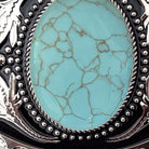 Two options for belt buckles: Option 1 has a leaf pattern and option 2 has flowers on it