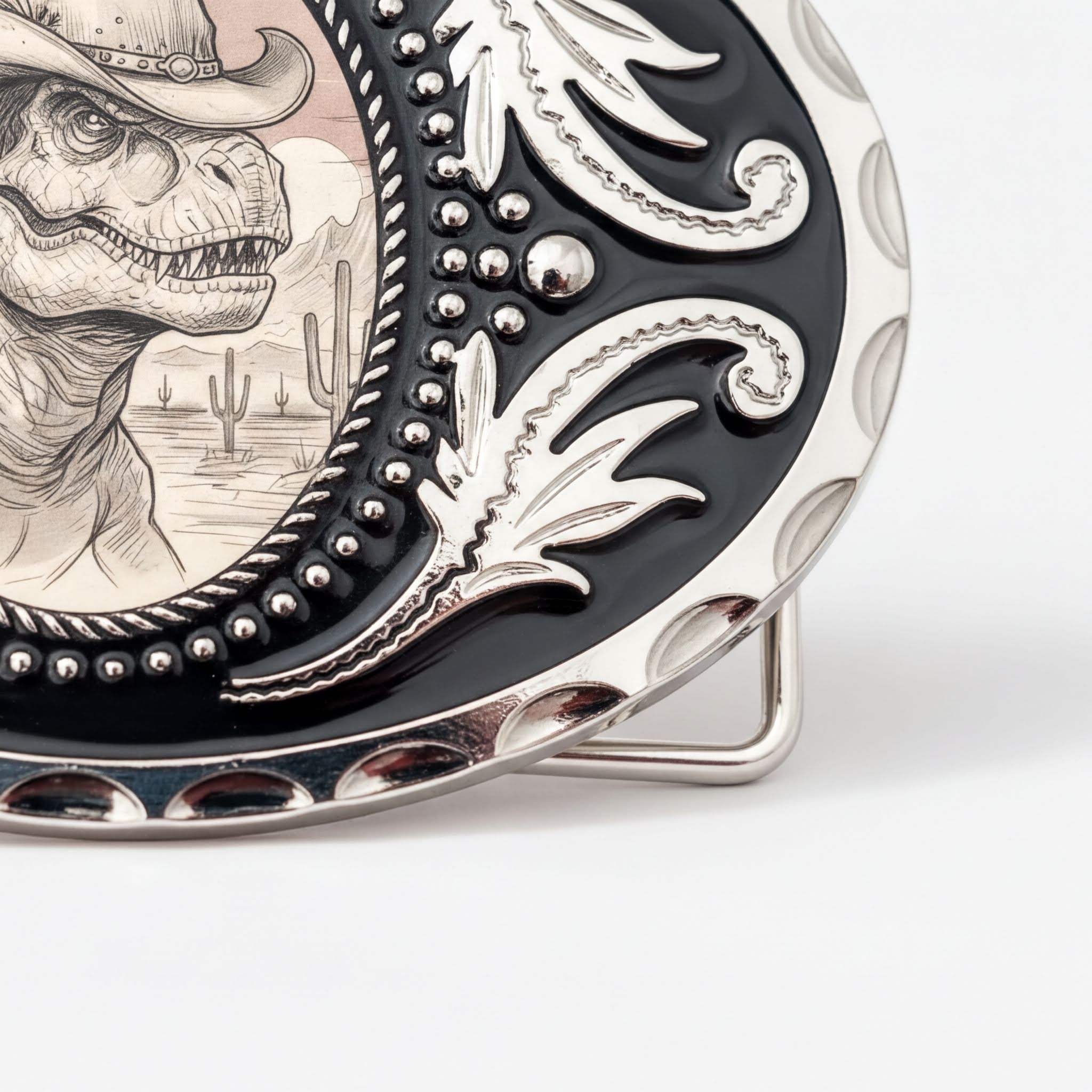 A decorative metal buckle featuring a detailed illustration of a dinosaur wearing a cowboy hat, with a desert landscape in the background.