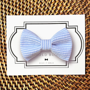 a blue and white striped bow tie on a card