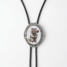 A silver oval-shaped pendant with a raccoon illustration on it, hanging from a black cord.