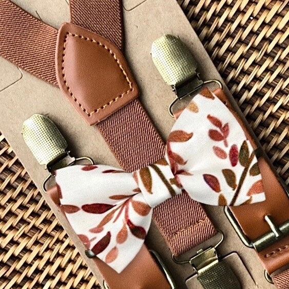 Cognac brown suspenders form a Y-back for men, groomsmen, groom or ring bearer outfit with a terracotta floral bowtie on a white background.