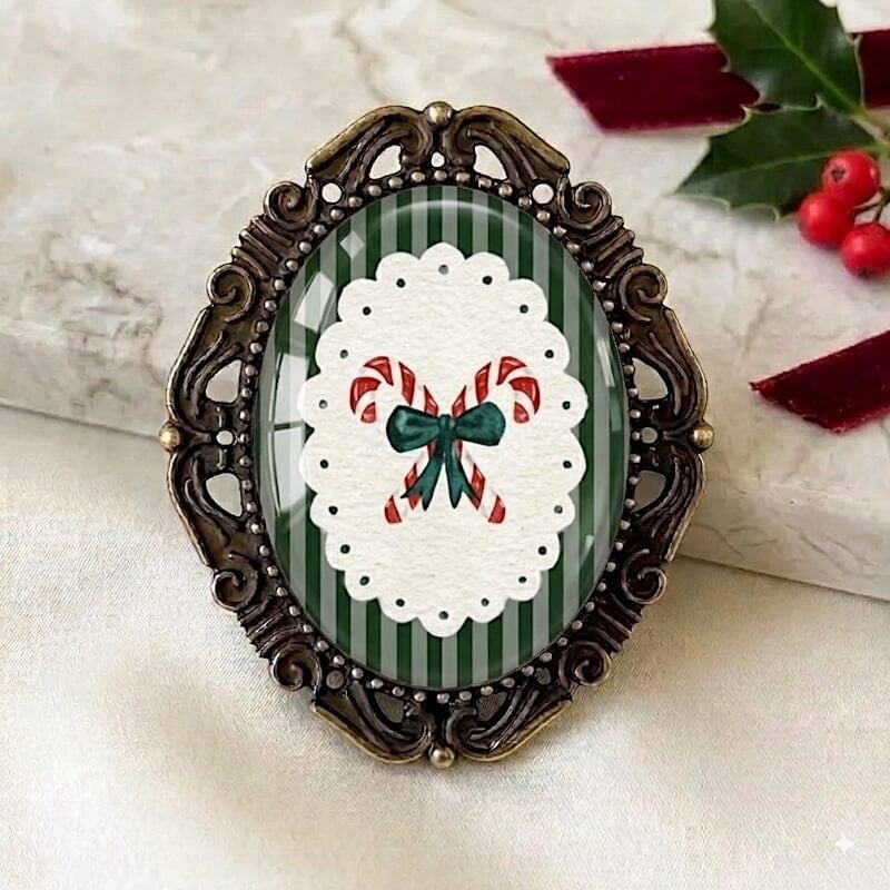 Festive holiday brooch with candy canes and green bow on striped background