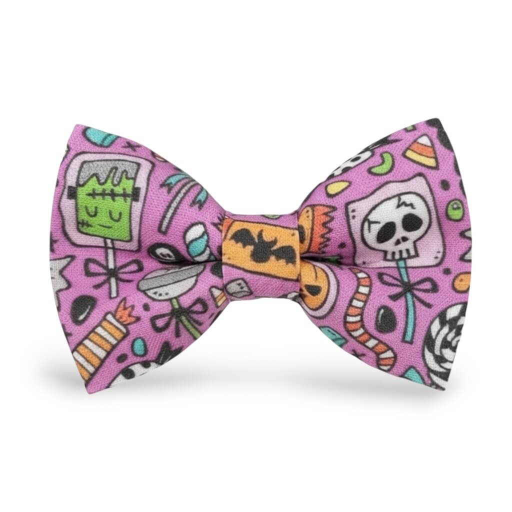 The Bold Bow Tie purple Halloween pre-tied bow tie featuring candy, skull, and monster print for spooky season.
