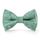 The Bold Bow Tie sage green cotton pre-tied bow tie with a delicate floral pattern for rustic wedding attire.