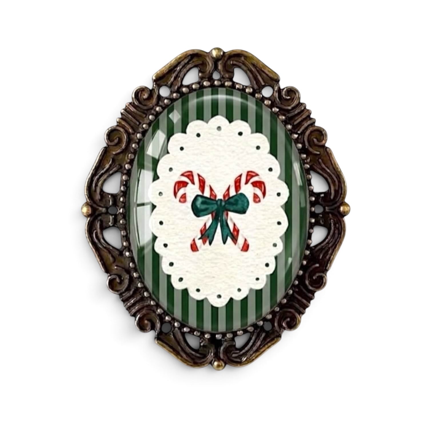 The Bold Bow Tie vintage-style Christmas brooch featuring candy canes on a green striped background in a bronze frame.