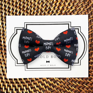 a black bow tie with red hearts on it