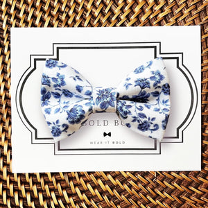 a blue and white bow tie sitting on top of a card