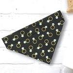 Load image into Gallery viewer, a black bandana with gold rings on it
