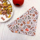 a dog bandana next to a bowl of dog treats