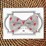 Load image into Gallery viewer, a bow tie that has hearts on it
