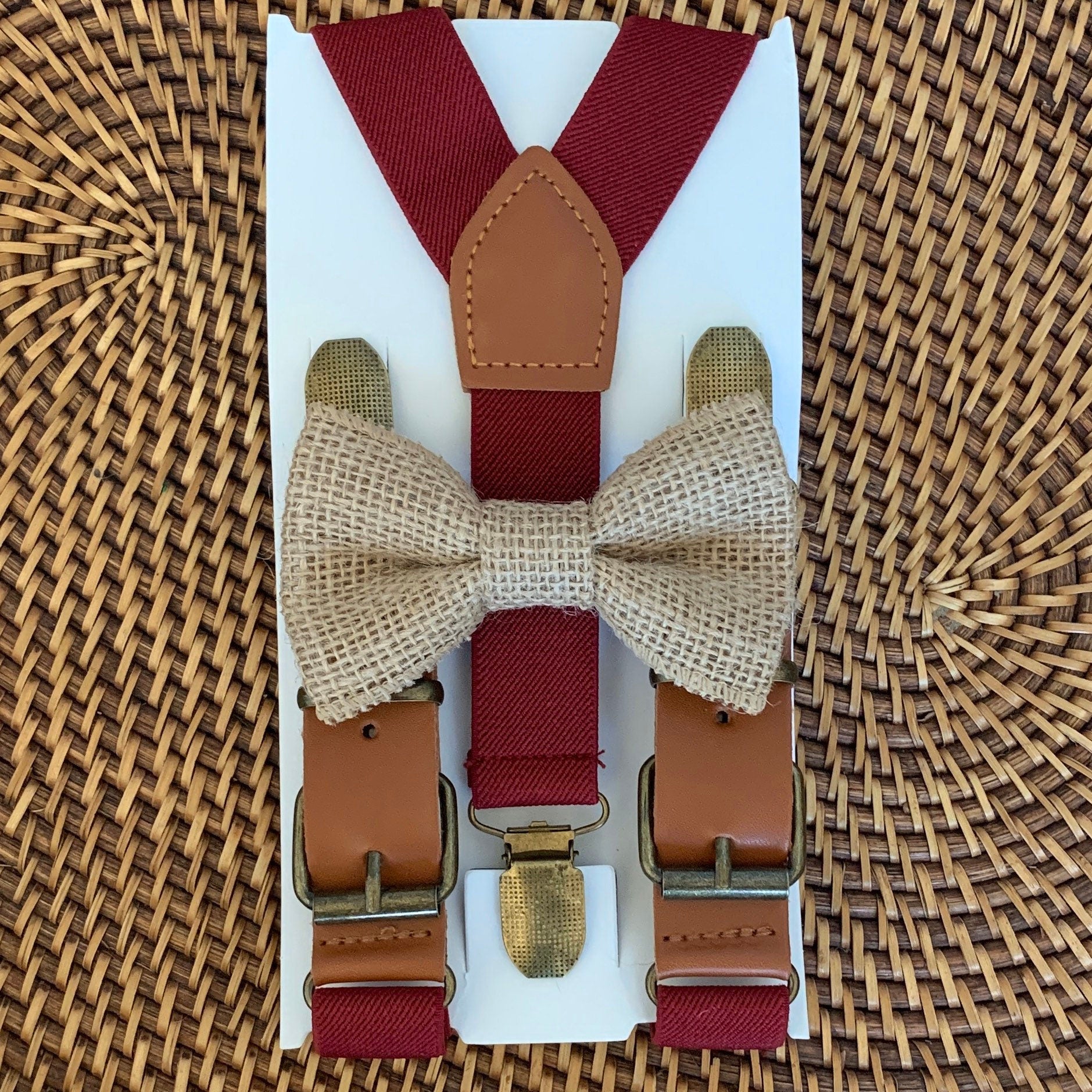 A country chic burlap bow tie and rustic burgundy buckle suspenders for men and boys to wear to a cowboy wedding.